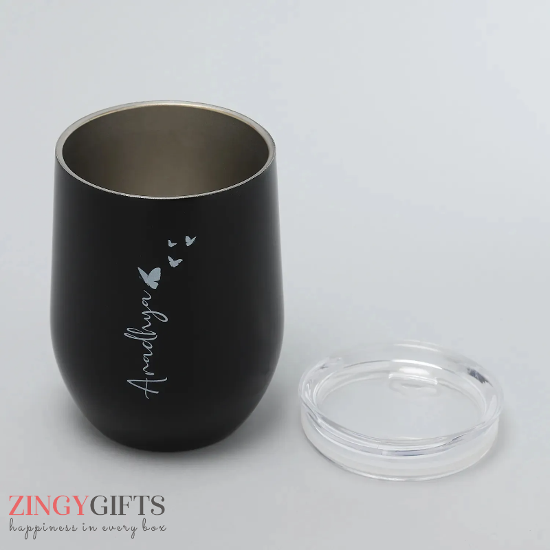 Black tumbler with 'Amalyn' engraving on a gray background, featuring the brand 'Zingy Gifts'.