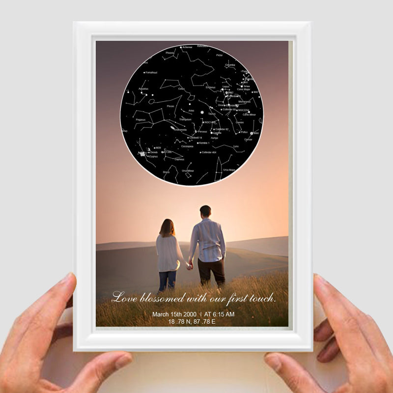 Framed artwork of a couple looking at a star map with personalized text.