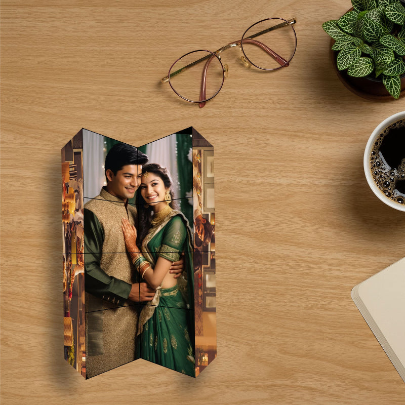 Wooden photo block with a couple in traditional attire on a wooden surface with glasses and a coffee cup.