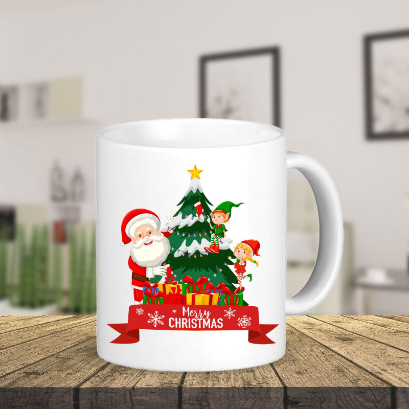 White mug with Christmas design featuring Santa Claus, elves, and a tree on a wooden table.