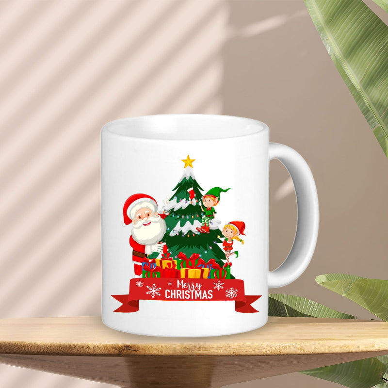 White mug with Christmas design featuring Santa Claus, elves, and a tree on a wooden surface.