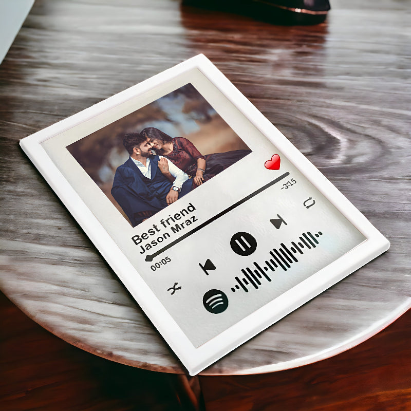 Framed photo of two people with music player design on a wooden surface