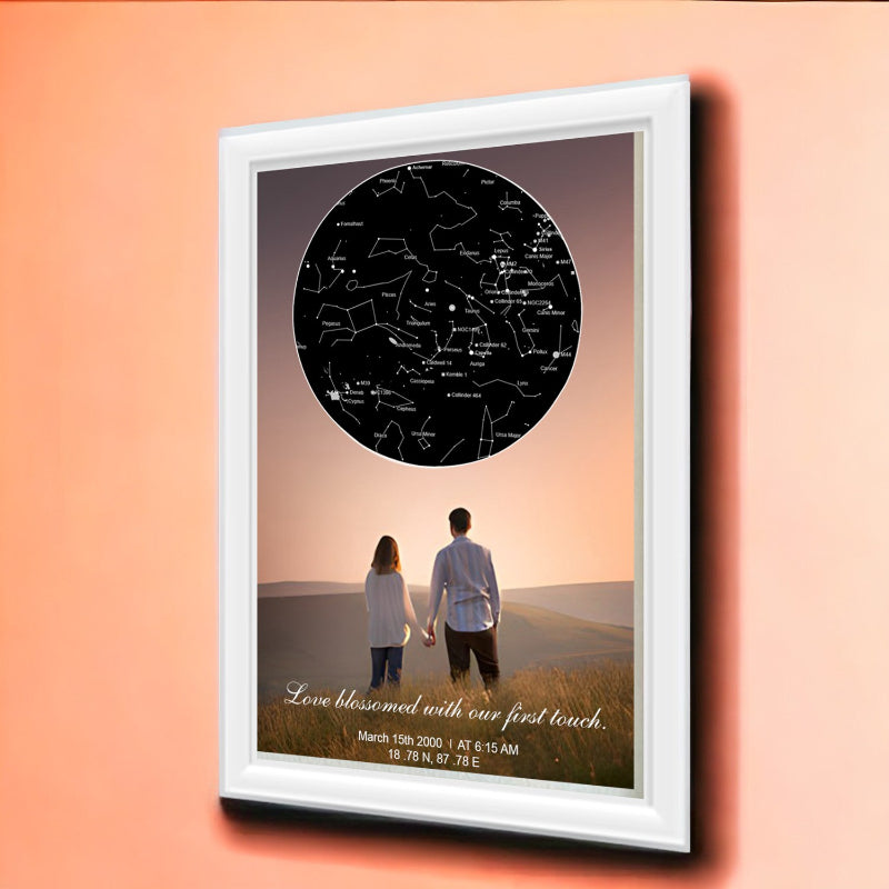 Framed artwork of a couple holding hands with a star map on a peach background
