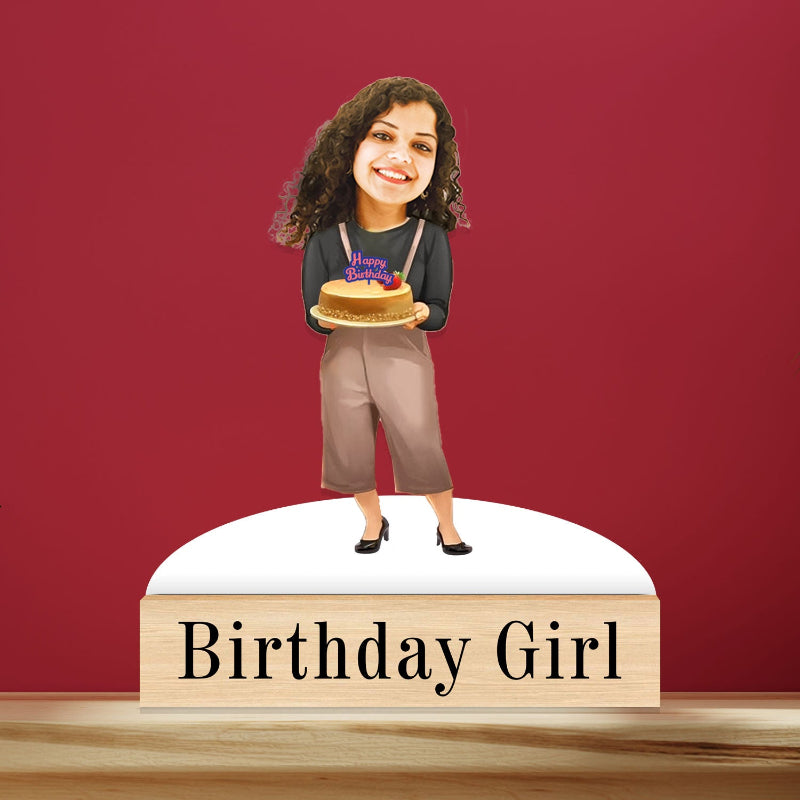 A personalized caricature of a smiling woman holding a cake with a 'Happy Birthday' sign, standing on a wooden base with the text 'Birthday Girl'.
