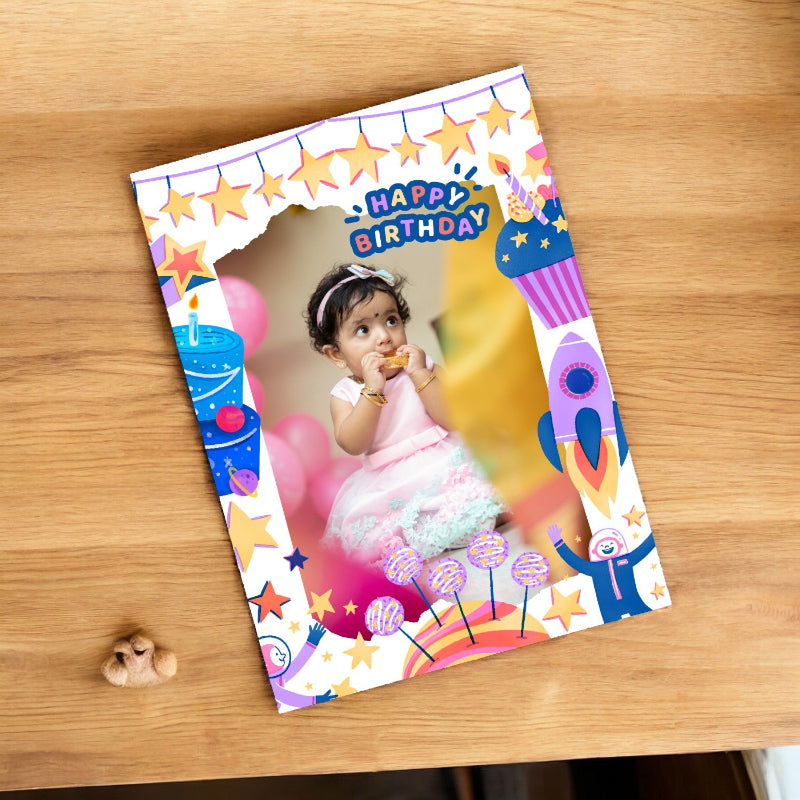 Colorful birthday card with a child's photo on a wooden surface