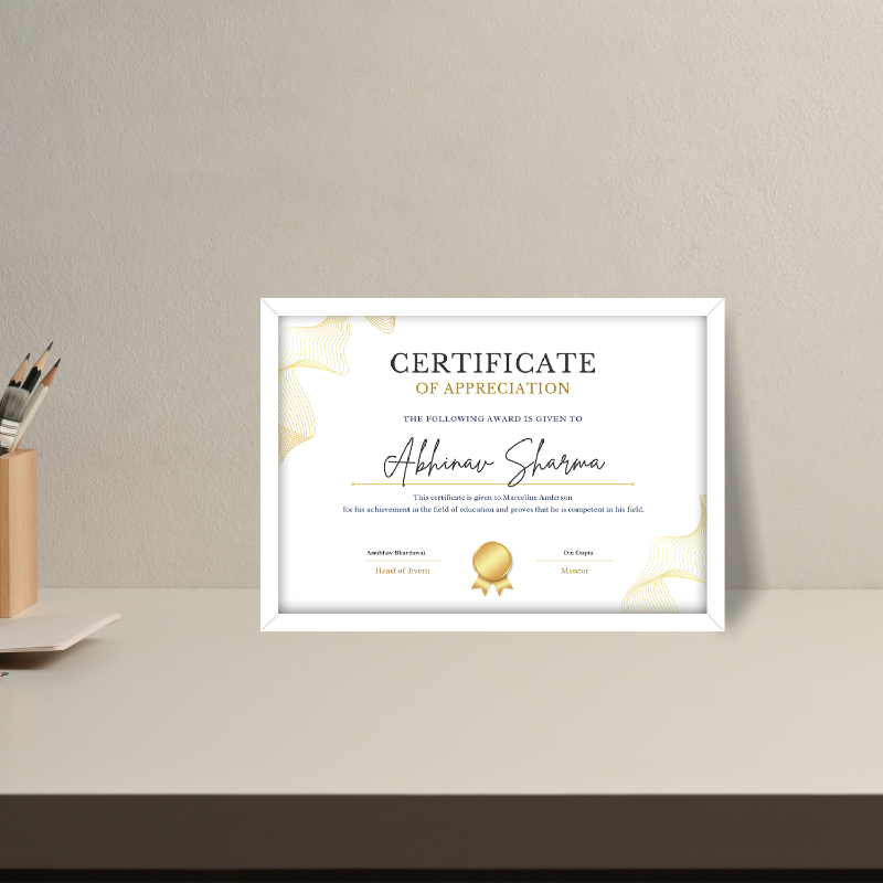 Framed certificate of appreciation on a wall with a pen holder in the corner.