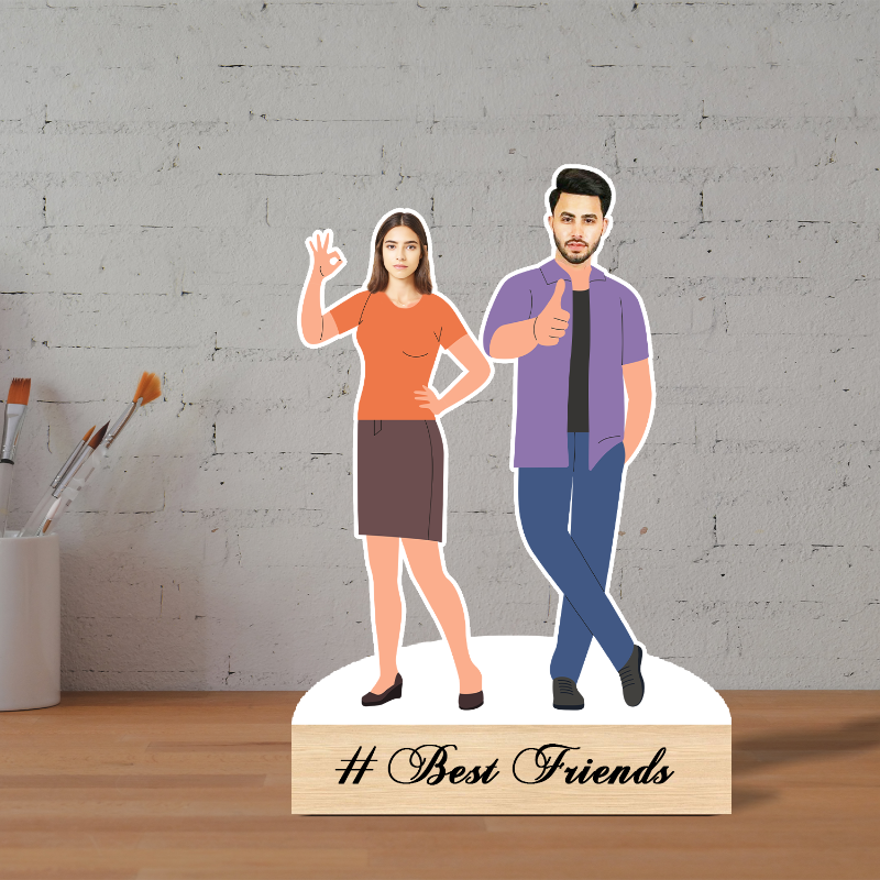 Cardboard cutouts of a man and woman on a stand with '# Best Friends' text, against a gray brick wall.