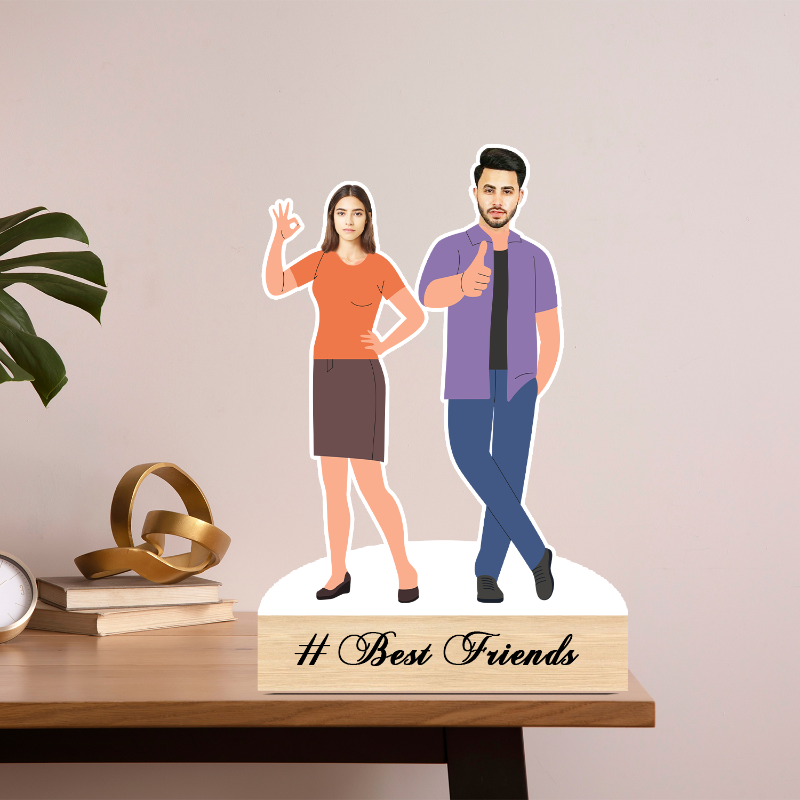 Figurines of a man and a woman on a stand with '# Best Friends' text, placed on a wooden surface.