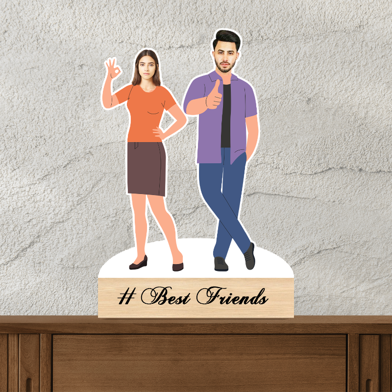 A customized caricature of two people standing next to each other with a wooden stand at the base, on a desk with a wall in the background. The caricature includes a text that reads '#Best Friends'.