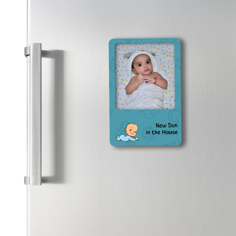Fridge magnet with a baby picture and text 'New Don in the House' on a white refrigerator.