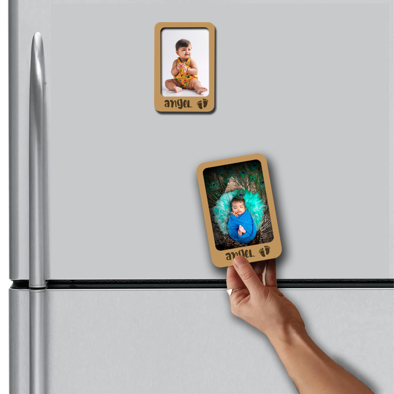 Hand placing a wooden photo frame magnet on a refrigerator with another magnet already attached.