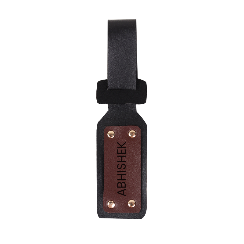 Black and brown luggage tag with 'ABHISHEK' engraving on a white background