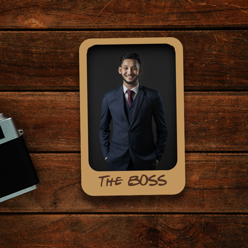 Man in a suit with 'The Boss' text on a wooden background