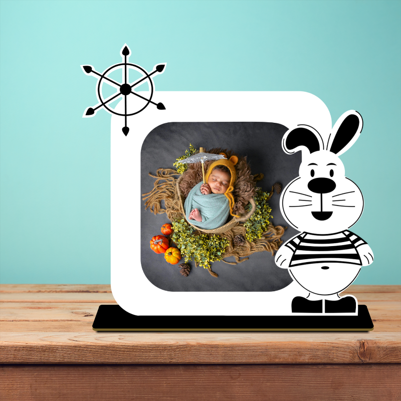 Decorative stand with a baby in a basket and a cartoon rabbit character on a wooden surface.