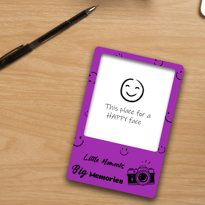 Purple card with smiley face design on a wooden surface