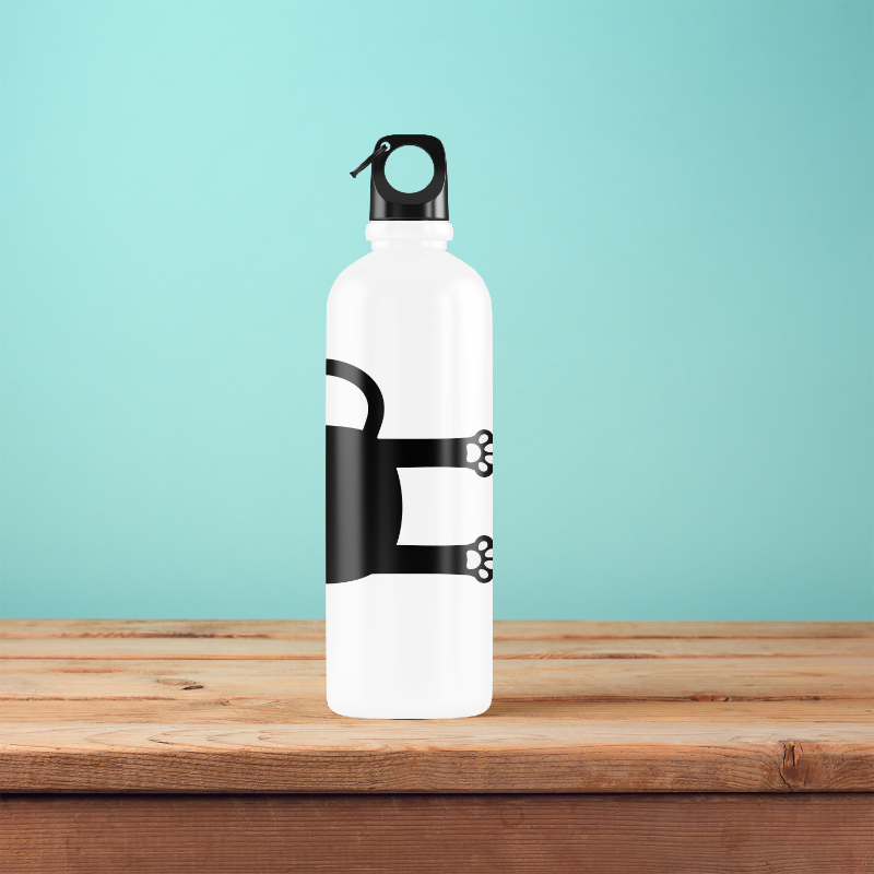 A white water bottle with a black printed design of a cat on it, placed on a wooden surface with a blue background.