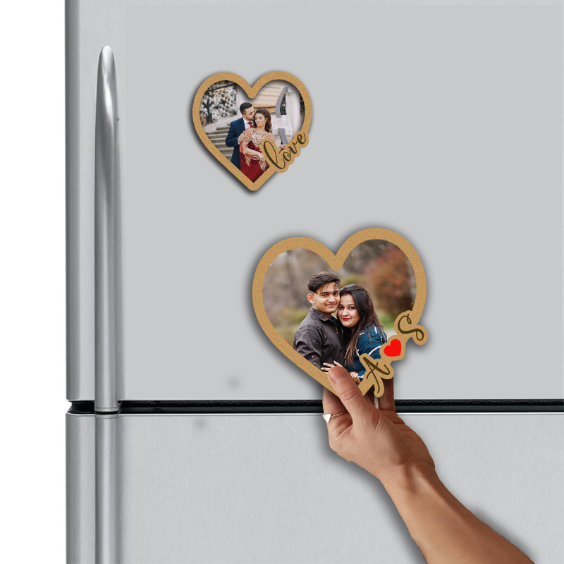 Heart-shaped photo magnet with a couple on a refrigerator