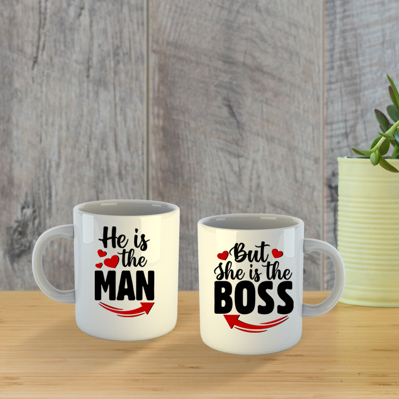 Two white mugs with humorous text design on a wooden surface.