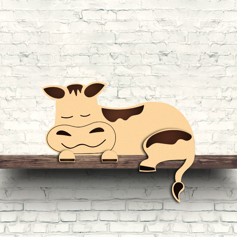 A wooden cow shelf decor with a brown and white color scheme, resting on a shelf against a white brick wall background.