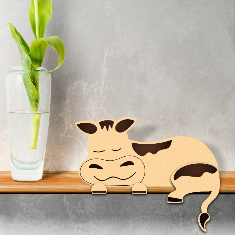 Wooden hippo decoration on a shelf with a glass of water and plant in the background
