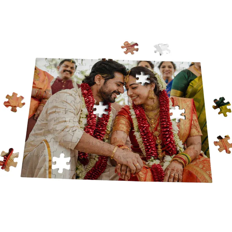 Jigsaw puzzle with a couple in traditional attire surrounded by friends on a white background