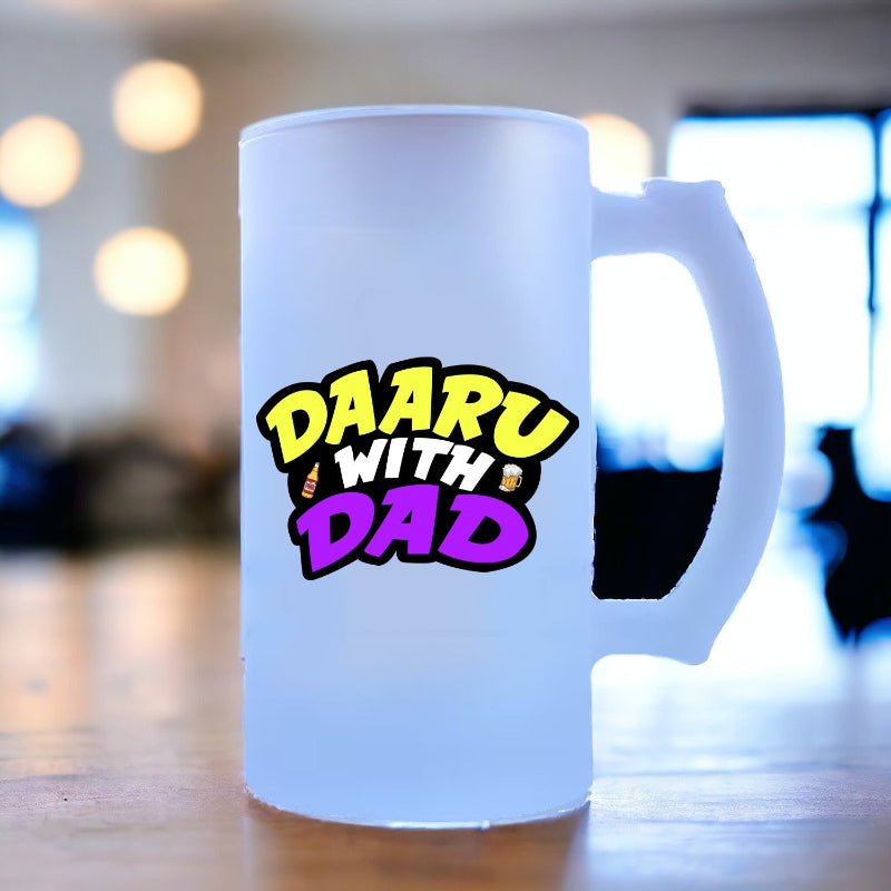 A white ceramic beer mug with 'Daaru with Dad' text and colorful design, placed on a table.