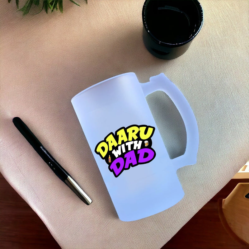 Frosted mug with 'Daaru with Dad' text on a light surface with a pen and black container.