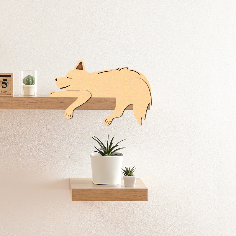 Wooden dog-shaped decor item on a shelf with plants and a calendar in the background.