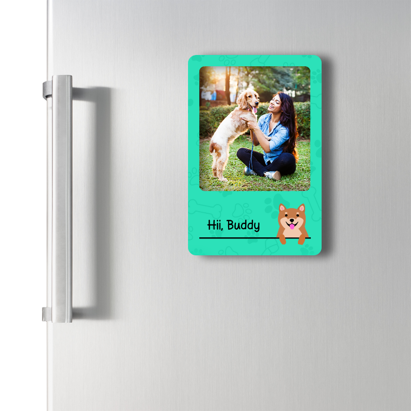 Fridge magnet with a photo of a woman holding a dog and text 'Hi, Buddy' on a green background.