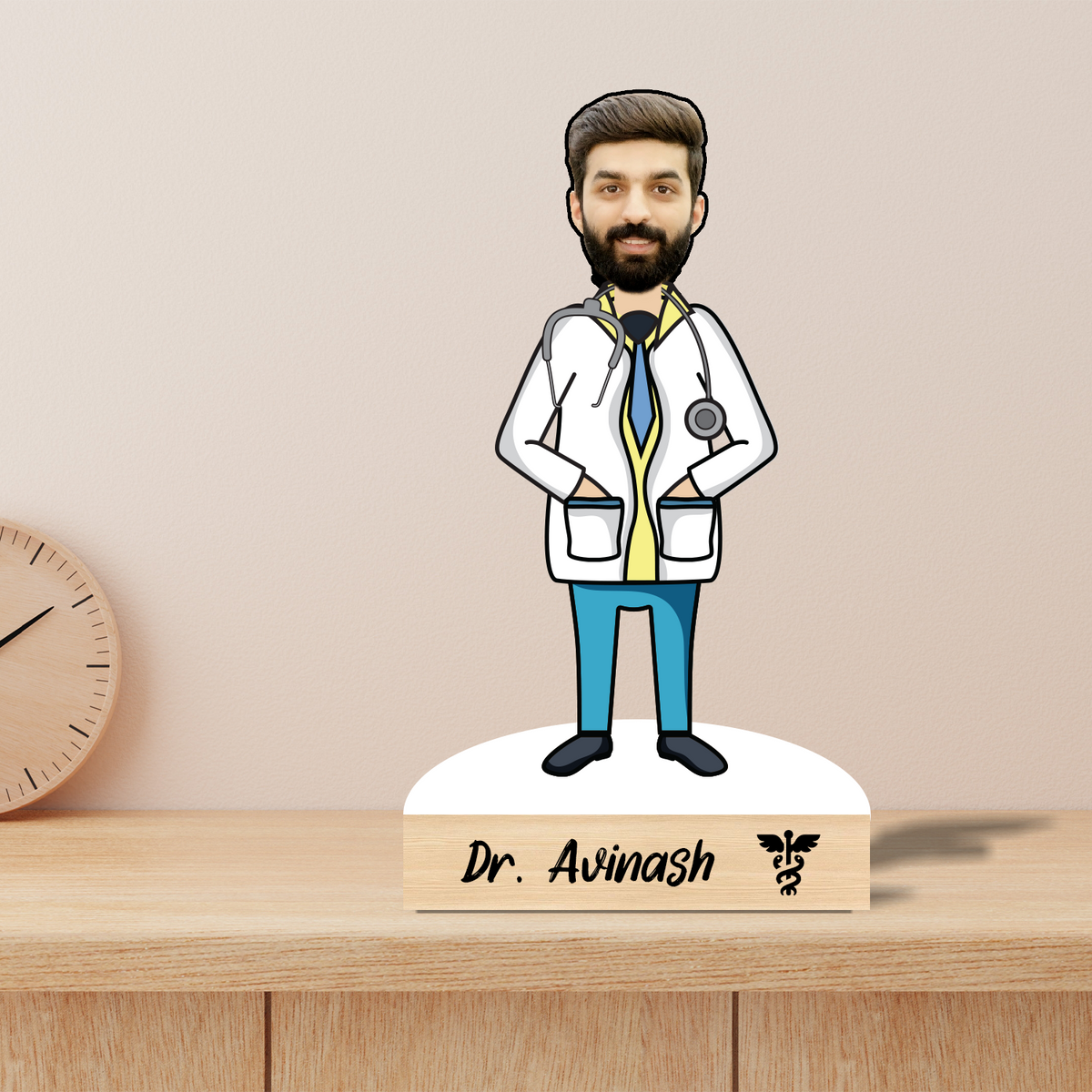A personalized wooden caricature of a doctor with a beard, wearing a white coat, standing on a wooden base which includes a name and a small logo.