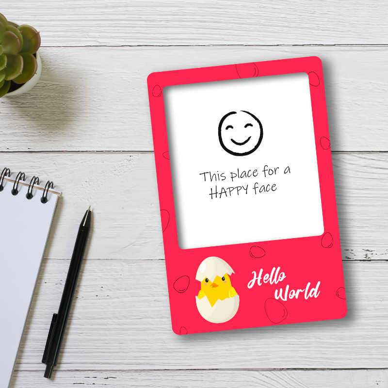 Children's drawing board with a red frame on a wooden surface, featuring a chick and text.