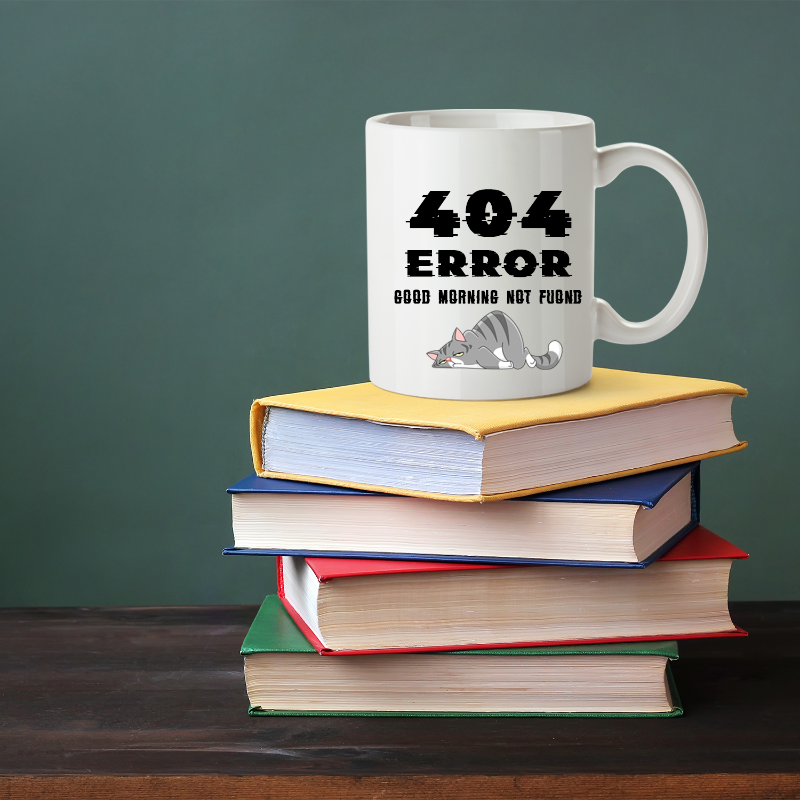 Mug with '404 Error Good Morning Not Found' text on a stack of books against a green background
