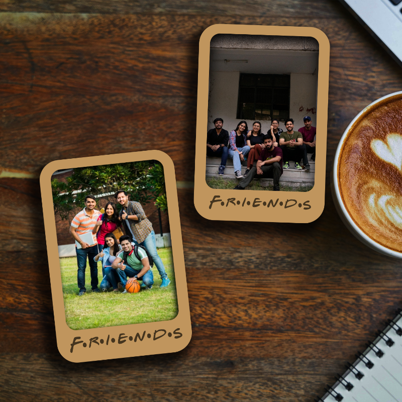 The image shows two personalized wooden fridge magnets. One magnet has a photo of a group of friends posing together, and the other has the text 'Friendship' with a heart symbol.