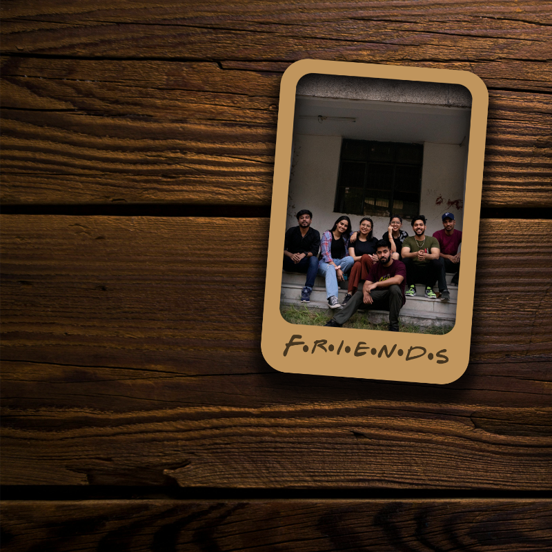 Memorabilia card with a photo of a group of people on a wooden surface