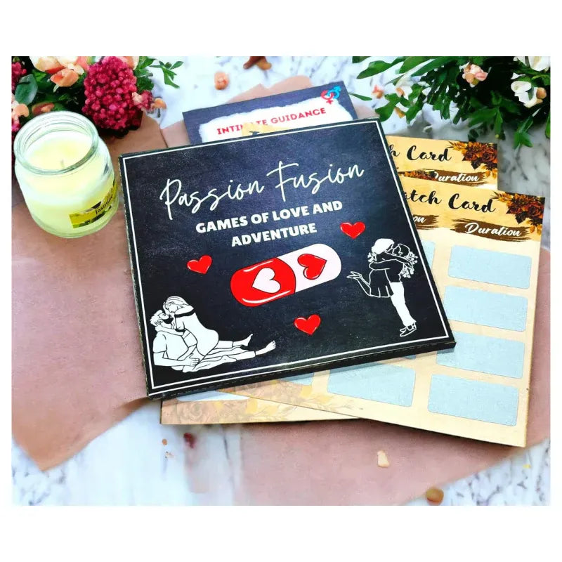 Card game packaging titled 'Passion Fusion: Games of Love and Adventure' on a marble surface with flowers and a candle.
