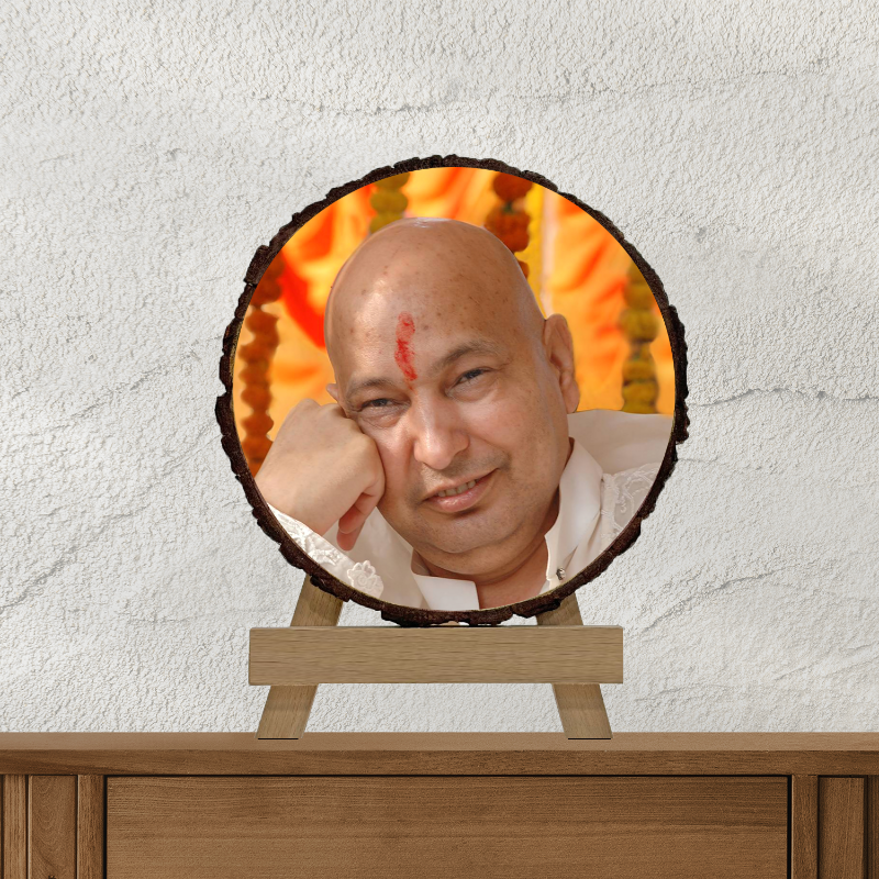 Circular photo frame with a person's face on a stand against a textured white wall.