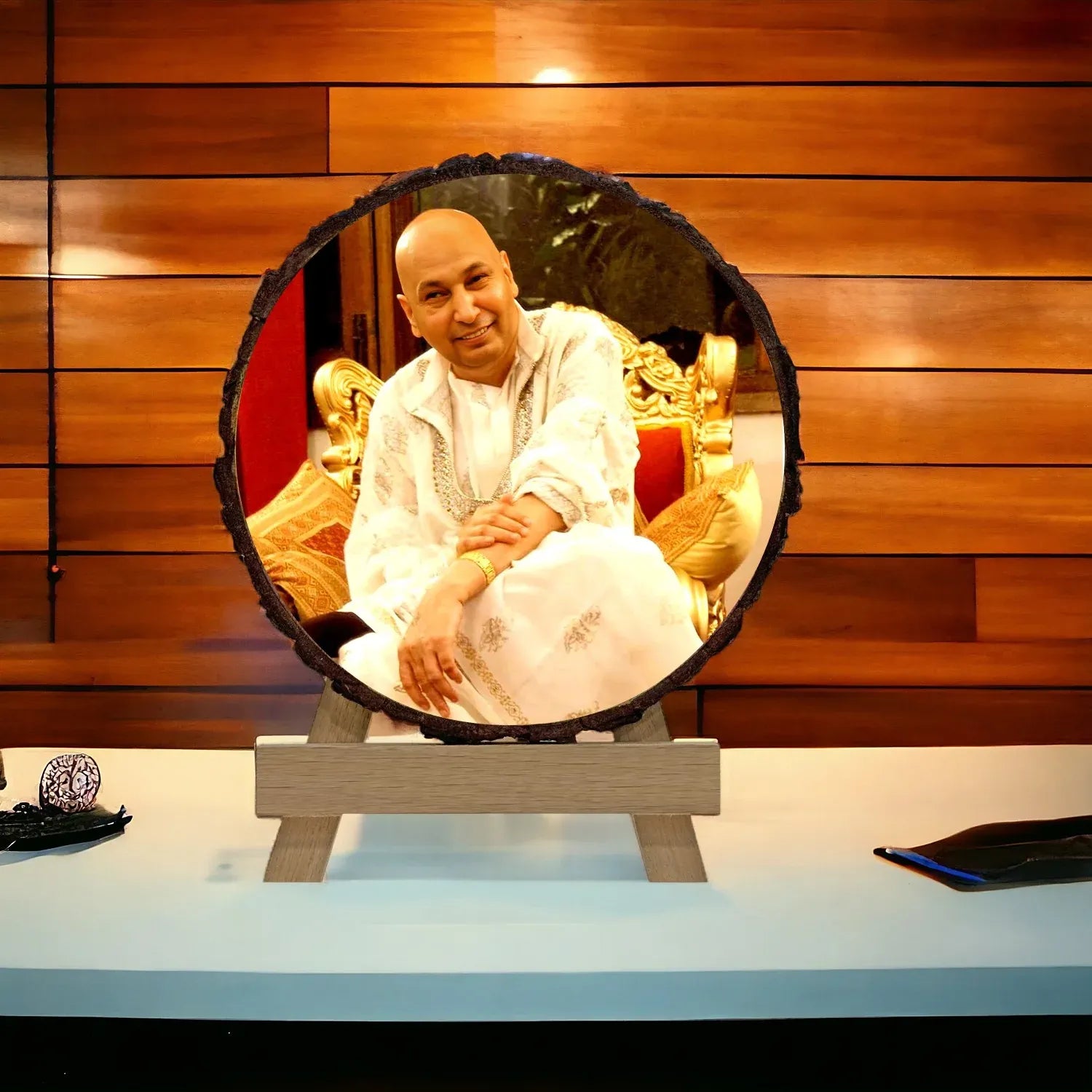 Man sitting on a decorative chair with a wooden panel background