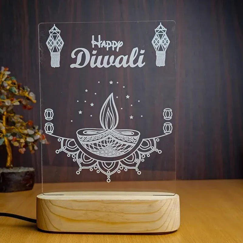 Decorative lamp with 'Happy Diwali' text and traditional elements on a wooden base.