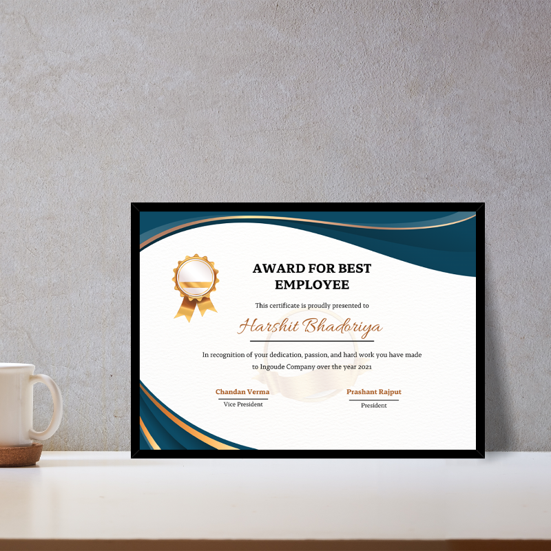 Framed certificate for best employee on a desk with a mug and coaster.