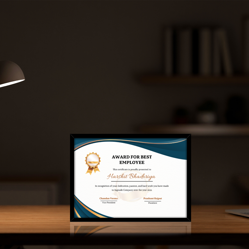 Framed award for best employee on a desk with a blurred background