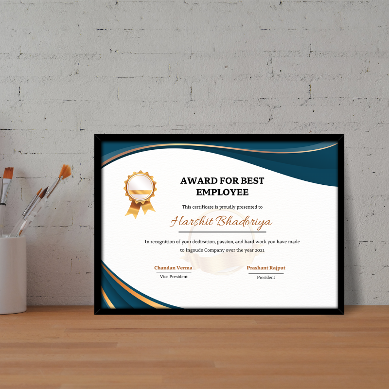Framed certificate for 'Best Employee' on a wooden surface with a gray brick wall background