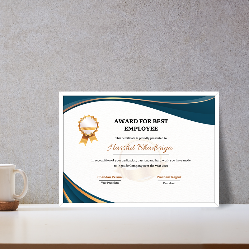 Framed certificate for best employee on a desk with a mug and coaster.