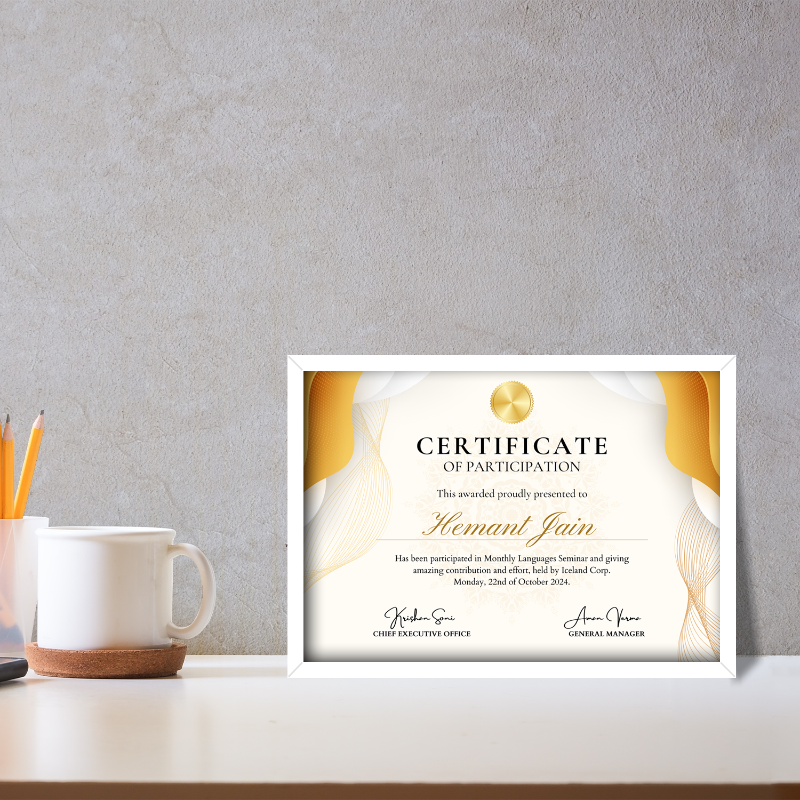 Framed certificate of participation on a desk with a mug and pencils.