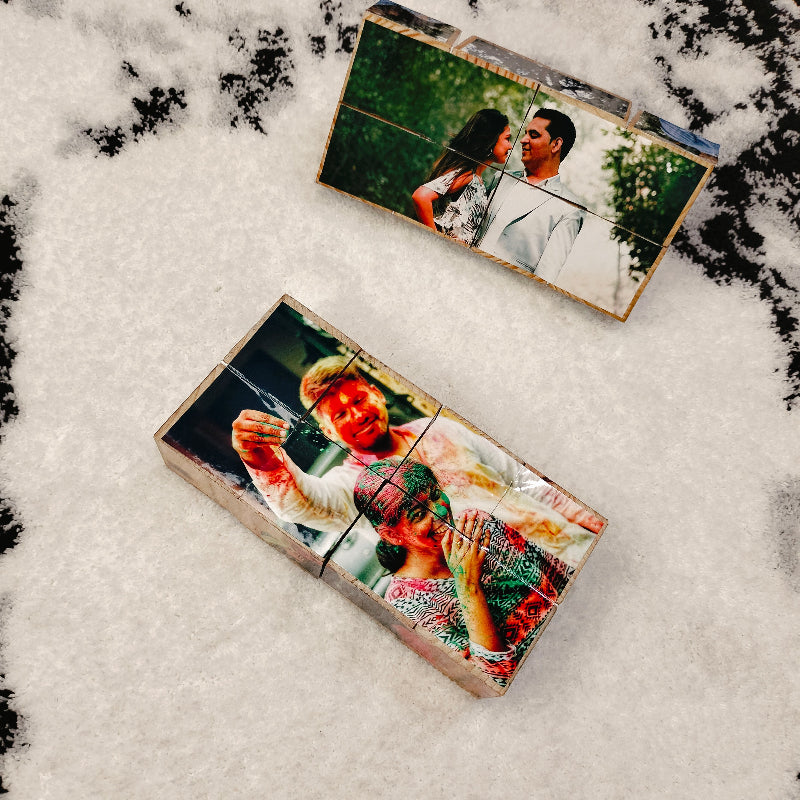 Two wooden photo puzzles with printed images of a couple on a snowy background