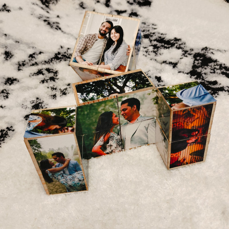 Wooden photo cubes with images of a couple on a snowy background