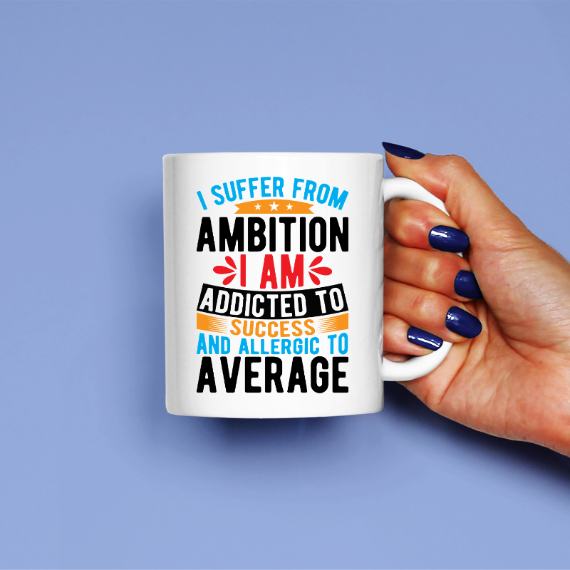 A white ceramic mug with printed text that reads: 'I suffer from AMBITION I am ADDICTED to SUCCESS and ALLERGIC to AVERAGE'.