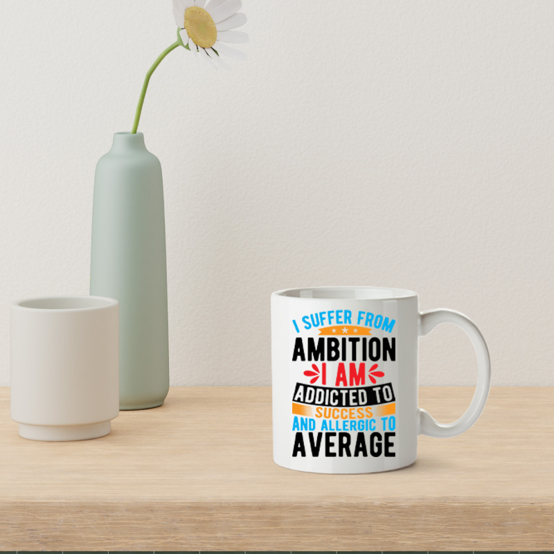 Mug with motivational quote on a wooden table with a vase and flower in the background