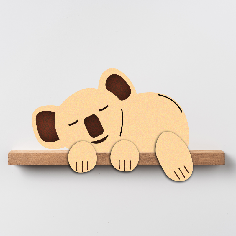 A wooden figurine of a sleeping koala positioned on a shelf.