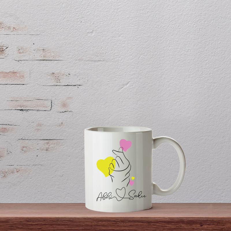 White mug with a design on a wooden surface and light gray background