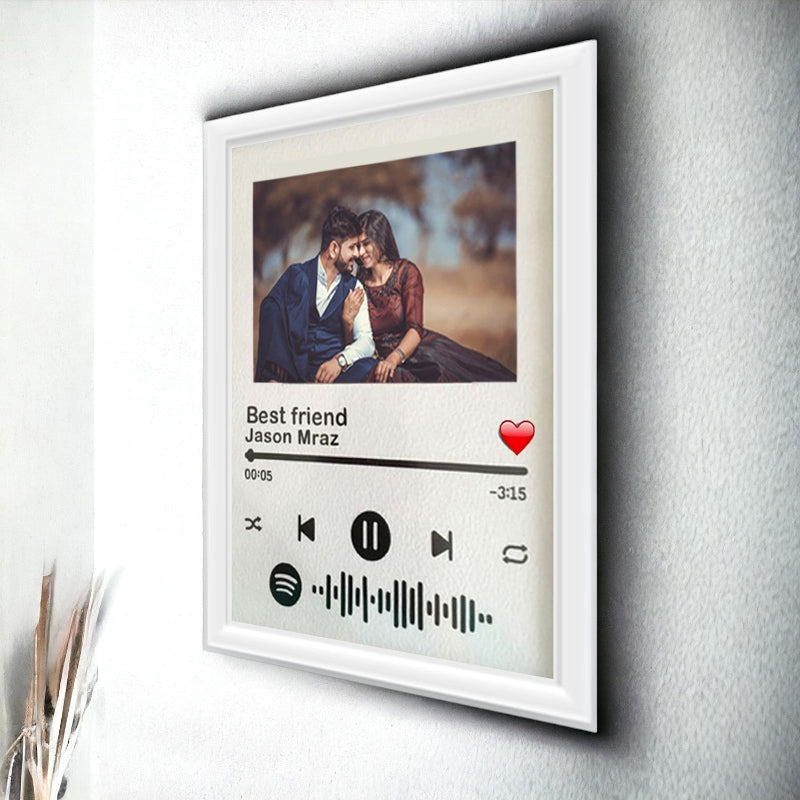 Framed artwork with a couple's photo, music player interface, and 'Best friend' text on a white wall.